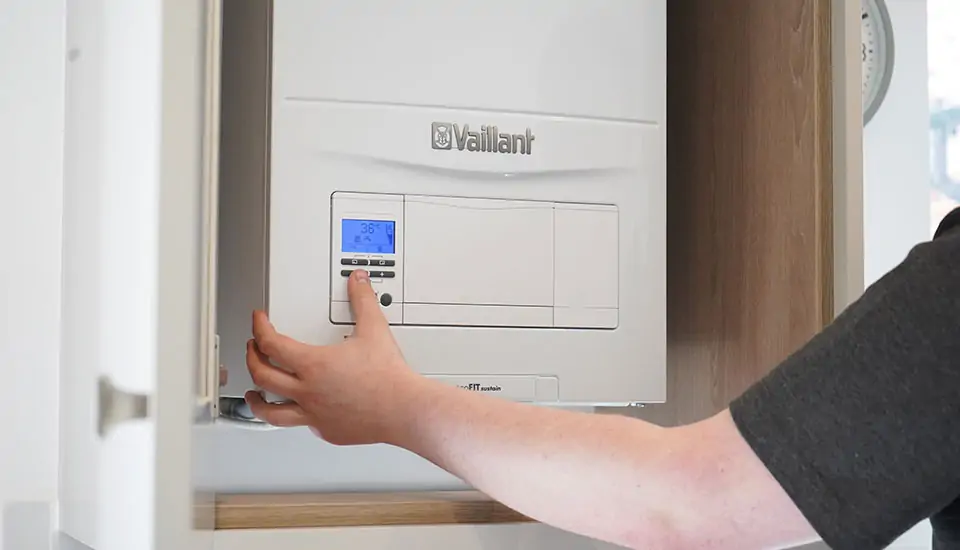 Engineer changing boiler settings